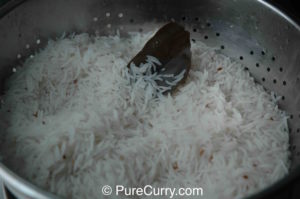 Boiled rice in colander