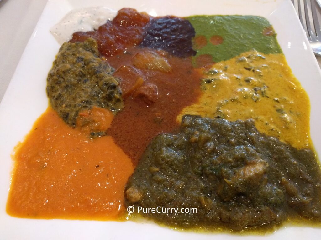 A plate of Indian sauces in different colors and textures. 
